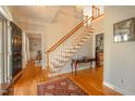 Elegant foyer with hardwood floors, a staircase, and a glimpse into adjacent living areas at 1229 Westerham Dr, Wake Forest, NC 27587