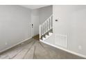 Entryway features a staircase, neutral carpet, and a bright, welcoming atmosphere at 129 Bridges Ln, Youngsville, NC 27596