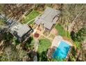 An aerial view shows a beautiful property with a pool, patio, and lush landscaping at 136 Carolina Forest Rd, Chapel Hill, NC 27516