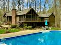 Relaxing pool view with outdoor seating area, a perfect place to unwind and enjoy the scenery at 136 Carolina Forest Rd, Chapel Hill, NC 27516