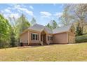 Beautiful single-Gathering home with mature landscaping, a neutral exterior, and an attached two-car garage nestled amongst tall trees at 1409 Turner Farms Rd, Garner, NC 27529