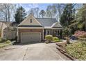 A charming brick home featuring a well-maintained yard and attached garage at 155 Chimney Rise Dr, Cary, NC 27511