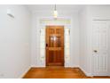 Inviting entryway with a beautiful wood door and sidelights leading into the home at 1638 Crystal Ln, Stem, NC 27581
