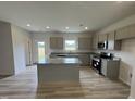 Modern kitchen featuring stainless steel appliances, a center island, and ample counter space at 168 Bruce Dr, Dunn, NC 28334