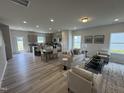 Spacious living room featuring modern decor, wood flooring, and lots of natural light at 168 Bruce Dr, Dunn, NC 28334