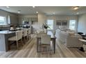 Open-concept living space with modern kitchen, dining area, and a comfortable living room at 168 Bruce Dr, Dunn, NC 28334