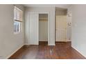 A bright bedroom featuring hardwood floors, a closet, neutral walls, and a window for natural light at 227 Coley Farm Rd, Fuquay Varina, NC 27526