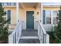 Inviting front entry with a wood porch, blue door and siding, and decorative blue shutters on the windows at 227 Coley Farm Rd, Fuquay Varina, NC 27526