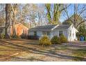 Residential home with quaint front yard landscaping and mature trees providing shade at 2457 Derby Dr, Raleigh, NC 27610