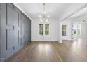 Bright dining room featuring elegant hardwood floors, a decorative gray wall, and large windows with natural light at 2809 Theresa Eileen Way, Raleigh, NC 27603