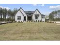 A newly built two-story home featuring a white brick facade and a freshly laid lawn at 2809 Theresa Eileen Way, Raleigh, NC 27603