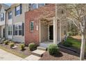 Inviting front porch with brick accents and lush greenery, ready for relaxation at 30 Holly Berry Ln, Durham, NC 27703