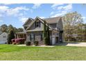 Well-maintained two-story home with stone accents, attached garage, and ample parking space at 3034 E Bay Court, Creedmoor, NC 27522