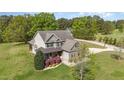 An exterior elevation view of a beautifully landscaped two-story home with a manicured lawn at 3034 E Bay Court, Creedmoor, NC 27522