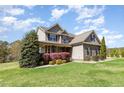 A charming two-story home featuring a stone facade and professionally landscaped front yard at 3034 E Bay Court, Creedmoor, NC 27522