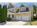Two story home featuring an attached two car garage, and a front porch at 304 Frontgate Dr, Cary, NC 27519