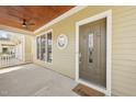 Covered front porch featuring a detailed front door, a ceiling fan, and wood ceiling at 304 Frontgate Dr, Cary, NC 27519