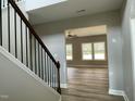 Open foyer with a view into a living area with multiple windows for natural light at 308 Busterfield Ct, Benson, NC 27504