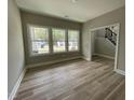 Bright living room featuring large windows and wood flooring, creating an inviting space at 308 Busterfield Ct, Benson, NC 27504