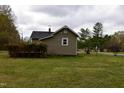 Exterior view of a house, highlighting its spacious backyard and wooden deck for outdoor enjoyment at 312 W Steele St, Gibsonville, NC 27249
