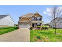 Beautiful two-story home with a spacious driveway, well-manicured lawn, and attractive landscaping at 343 Brinkley Cir, Mebane, NC 27302