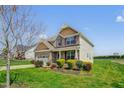 Inviting home with a two-car garage, charming front porch, and beautifully landscaped yard at 343 Brinkley Cir, Mebane, NC 27302