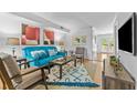 Bright living room featuring a comfortable blue sofa and stylish decor at 3743 Yorktown Pl, Raleigh, NC 27609
