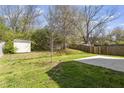 Large backyard area with a shed and a concrete slab for outdoor activities and entertainment at 3905 Joe And Ruth Lee Dr, Raleigh, NC 27610