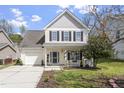 Two-story home with a front lawn, landscaping, an attached garage and covered entryway at 3905 Joe And Ruth Lee Dr, Raleigh, NC 27610