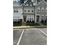 Street view of well maintained townhomes with dedicated parking spaces at 4423 Sugarbend Way, Raleigh, NC 27606