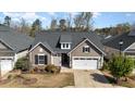 Inviting single-Gathering home showcasing a gabled roof, dormer window, two-car garage, and cozy front yard at 473 Abercorn Cir, Chapel Hill, NC 27516
