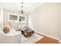 Cozy living room featuring hardwood floors, neutral furnishings, and abundant natural light from large windows at 473 Abercorn Cir, Chapel Hill, NC 27516
