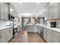 A modern, spacious kitchen with white countertops, stainless steel appliances and breakfast bar at 49 Olivia Crossing Ct # 43, Four Oaks, NC 27524