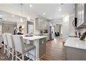 Bright, modern kitchen with stainless steel appliances, a large island, and hardwood floors at 49 Olivia Crossing Ct # 43, Four Oaks, NC 27524
