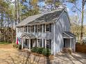 Beautiful exterior view of home highlighting siding, black shutters, landscaping and side entry at 5120 Knaresborough Rd, Raleigh, NC 27612