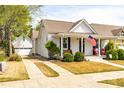 Charming white home with a welcoming front porch and detached garage via a long driveway at 524 Beckwith Ave, Clayton, NC 27527