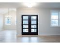Beautiful entryway featuring a contemporary glass-paned door and bright, neutral decor at 555 Vine Pkwy, Pittsboro, NC 27312