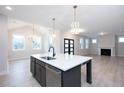 Modern kitchen with a large island, stainless steel appliances, and an open layout at 555 Vine Pkwy, Pittsboro, NC 27312