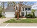 Charming two-story home with a well-manicured lawn, featuring a two-car garage and traditional architectural details at 6209 Remington Lake Dr, Raleigh, NC 27616