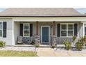 Inviting front porch with comfortable seating, stone accents, and a beautifully maintained walkway at 676 Wall Rd, Wendell, NC 27591