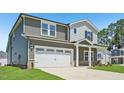 An eye-level exterior view of a two-story home, with a two car garage, manicured lawn, and inviting architecture at 700 Deschutes Dr, Garner, NC 27529