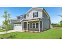 A lovely two-story home displays a two car garage, well-kept lawn, and attractive curb appeal at 700 Deschutes Dr, Garner, NC 27529