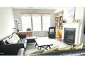 Inviting living room with a fireplace, comfortable seating, and large windows at 7125 Crested Iris Pl, Durham, NC 27703