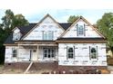 New construction home exterior with brick foundation and siding installation in progress at 801 Emmett Ct, Spring Hope, NC 27882