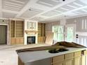 Spacious living room showcasing built-in shelving, a fireplace, and great natural light from surrounding windows at 801 Emmett Ct, Spring Hope, NC 27882