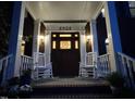Inviting front porch with comfortable seating, classic brickwork, and elegant entry door with decorative transom window at 8508 Kayenta Ct, Wake Forest, NC 27587