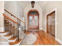 Elegant foyer with hardwood floors, grand staircase and decorative lighting at 915 Dunleigh Dr, Burlington, NC 27215