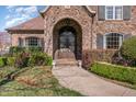Stone home featuring an arched front entrance with custom ironwork at 915 Dunleigh Dr, Burlington, NC 27215