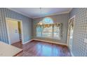 Charming dining room with beautiful hardwood floors and a large window at 98 Lochridge Dr, Roxboro, NC 27573