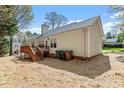 The backyard presents a wooden deck accessible by stairs, with adequate yard space at 105 Damask Rose Dr, Holly Springs, NC 27540